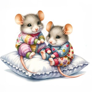 May include: Two cute gray mice wearing colorful pajamas are cuddling on a white pillow with ruffled edges.