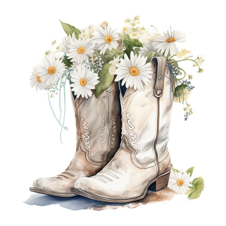 Puede incluir: Un par de botas vaqueras blancas con detalles marrones est&aacute;n llenas de un ramo de margaritas blancas y follaje verde.