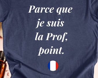 May include: Heather navy blue t-shirt with white text that reads "Parce que je suis la Prof, point." and a small French flag graphic.