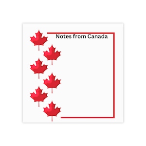 May include: A white card with a red border and the text "Notes from Canada" in black. The card is decorated with red maple leaves.