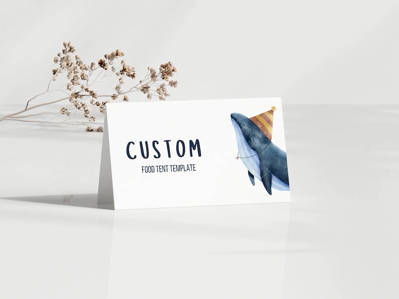May include: A white food tent template with the text "CUSTOM FOOD TENT TEMPLATE" in navy blue. A watercolour illustration of a blue whale wearing a yellow and orange party hat is on the right side of the template.