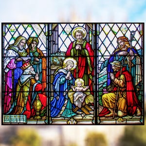 May include: A stained glass window depicting the Nativity scene.  The central figures are Mary, Joseph, and the baby Jesus.  Three wise men are shown approaching the manger, each carrying gifts.  The window is framed in a grid pattern and features a variety of colors, including red, blue, green, and gold.