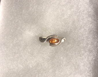 May include: A silver wire wrapped ring with an orange gemstone.