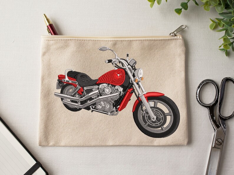 May include: A red and silver motorcycle embroidered on a beige canvas zippered pouch.
