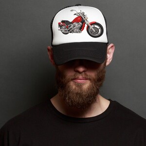 May include: A black trucker hat with a white mesh back. The front of the hat features a red and silver motorcycle graphic.