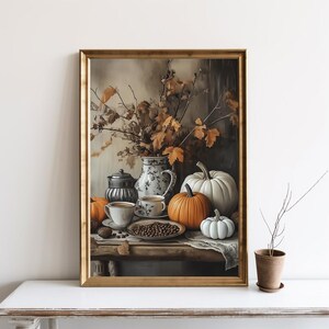 May include: A still life painting featuring a white teapot, two cups of coffee, a plate of coffee beans, and three pumpkins. The pumpkins are orange and white, and the background is a muted brown with fall leaves.