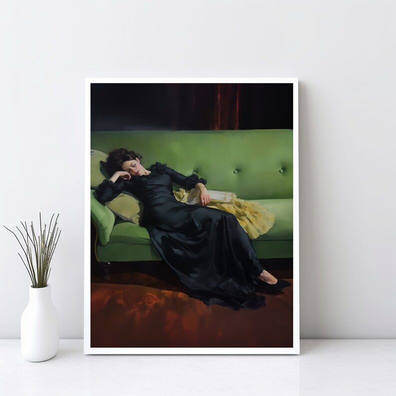 May include: A woman in a black dress is lying on a green velvet sofa. She is asleep with her head resting on a pillow. The sofa has a tufted back and arms.