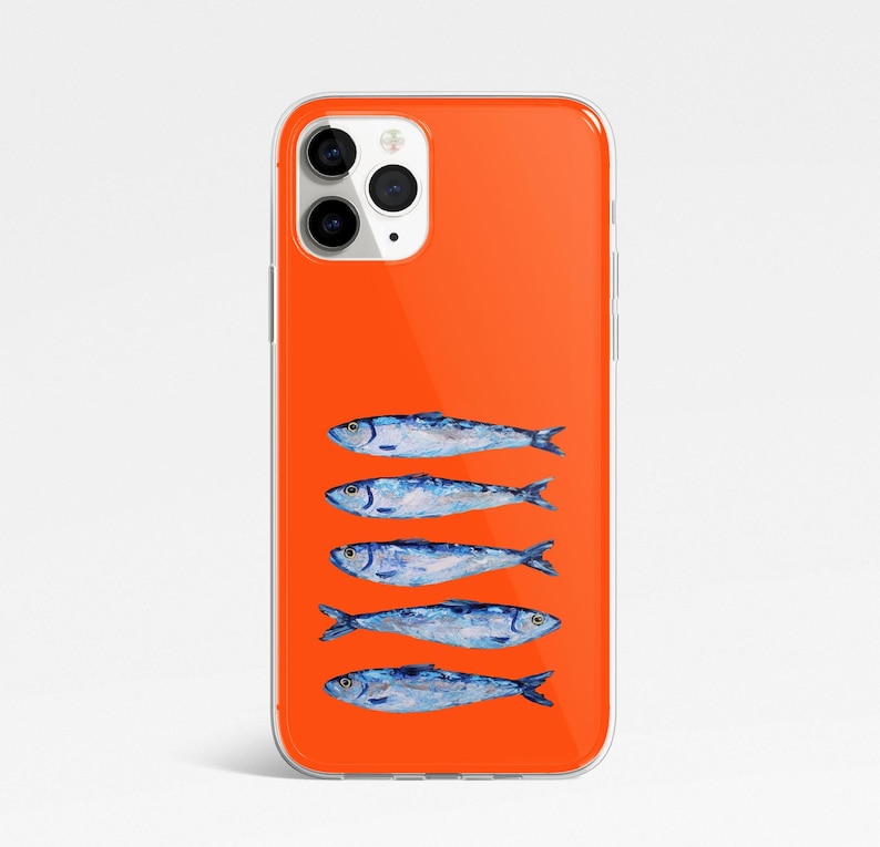 May include: A clear phone case with a bright orange background and a row of five blue and silver fish printed on the back.