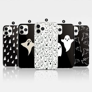 Pode incluir: Cinco capas de telefone diferentes com fundo preto e desenhos de fantasmas brancos. Os desenhos incluem um único fantasma, um fantasma com uma coroa e um padrão de fantasmas.