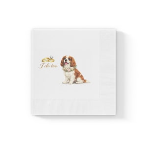 May include: White paper napkins with a Cavalier King Charles Spaniel illustration wearing a floral collar. Gold wedding rings and the text "I do too" are also featured. The napkins have a ribbed edge.