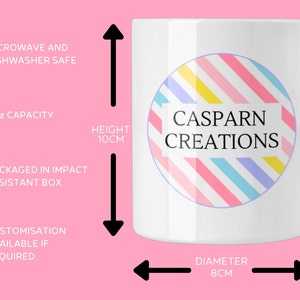 May include: White ceramic mug with a colorful circular design and the text "CASPARN CREATIONS." The mug has an 11oz capacity, is 10cm tall, and 8cm in diameter. It is microwave and dishwasher safe.