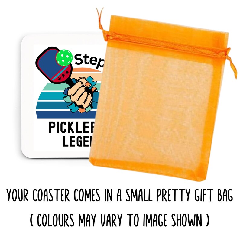 May include: A white square coaster with a pickleball paddle and ball design, the text "PICKLEBALL LEGEND" is printed on the coaster. The coaster is packaged in an orange gift bag.