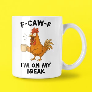 May include: White ceramic mug featuring a cartoon chicken holding a coffee cup. The mug has the text "F-CAW-F" above the chicken and "I'M ON MY BREAK" below the chicken.