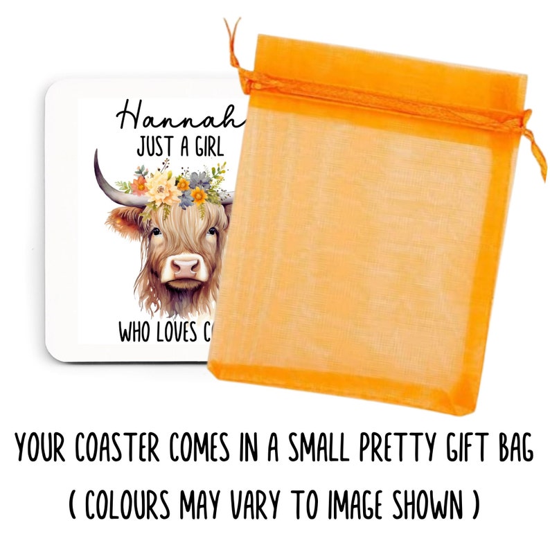 May include: A white square coaster featuring a watercolor illustration of a Highland cow wearing a floral crown. Text reads "Hannah JUST A GIRL WHO LOVES C". The coaster is next to an orange gift bag.