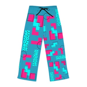May include: Blue pajama pants with a geometric pattern in pink and turquoise. The pattern includes squares, rectangles, and circles.
