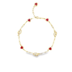 May include: A gold bracelet with red heart charms and small gold charms. The bracelet has a lobster clasp closure.