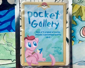 May include: A sealed package containing a card with the text "Pocket Gallery". The card features a pink cartoon character with a paintbrush and a red beret. The card also includes the text "Pack of 5 original artworks, includes a guaranteed sparkly card!"