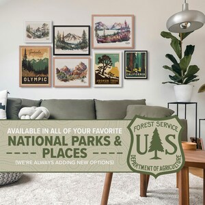 Living room gallery wall featuring a collection of vintage style US National Park posters, including Olympic, Joshua Tree, and Glacier. Perfect adventure gift decor.
