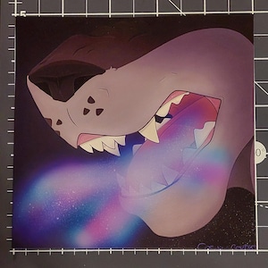 May include: Illustration of a stylized shark head with open jaws, revealing a colorful, galaxy-like interior. The shark is primarily gray with a dark brown upper section. A vibrant, multi-colored stream emanates from its mouth.