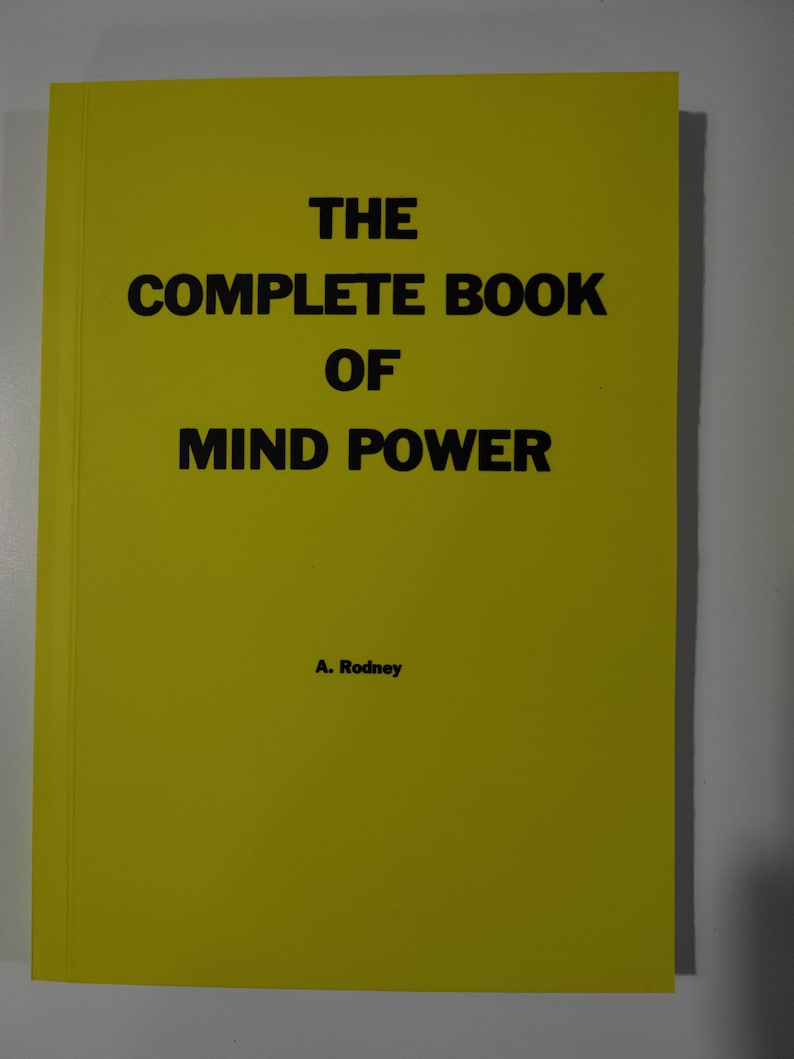 May include: A yellow book with the title "THE COMPLETE BOOK OF MIND POWER" and the author's name "A. Rodney" printed on the cover.