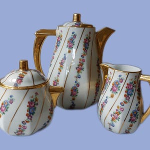Juego de desayuno Art Déco Frugier de porcelana de Limoges con motivos florales, tetera, azucarero y cremera