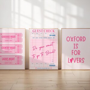 May include: Three framed pink prints. The left print features three tickets for "Karaoke Night", "Country Night", and "Ladies Night". The center print is a pink guest check with the text "Do you want to go to Brick?". The right print says "Oxford is for Lovers".