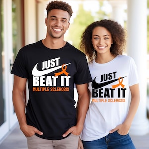 May include: Two t-shirts with the text "Just Beat It Multiple Sclerosis" and a Nike swoosh with an orange ribbon. The t-shirts are black and white.