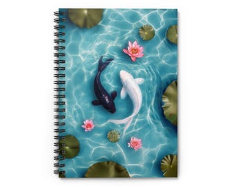 May include: Spiral-bound notebook featuring a serene design of two koi fish, one black and one white, swimming in a turquoise pond with lily pads and pink lotus flowers. The cover art evokes a sense of tranquility and natural beauty.
