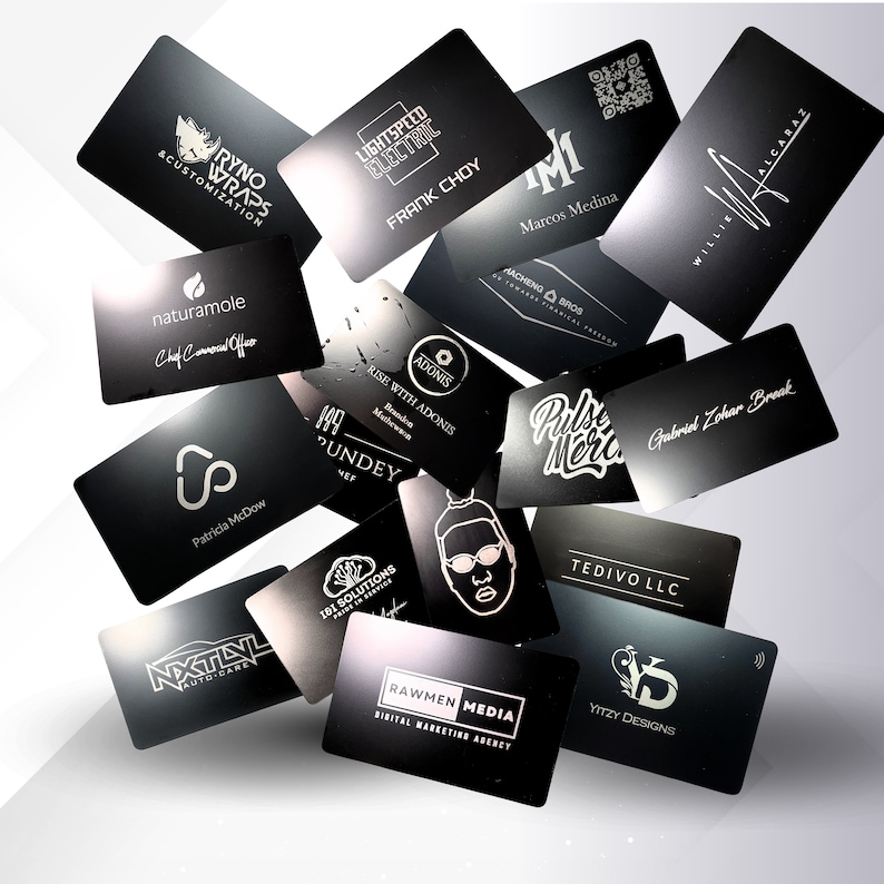 May include: A collection of black business cards with various logos and text, including "RYNO WRAPS", "LIGHTSPEED ELECTRIC", "FRANK CHOY", and "Marcos Medina". The cards are scattered against a white background.