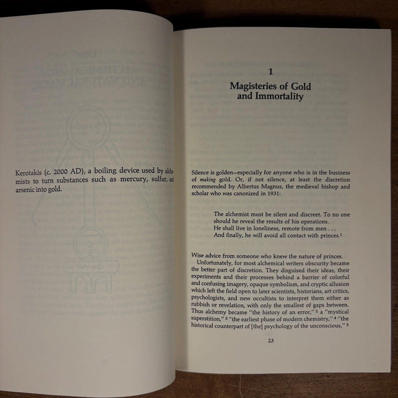 May include: Open book pages with text about alchemy, including the title "Magisteries of Gold and Immortality." The text describes the Kerotakis, a boiling device, and discusses the secrecy of alchemists. The page number 23 is visible.