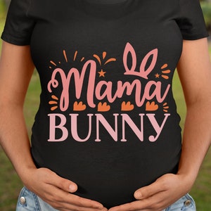 May include: A black t-shirt with the text "Mama Bunny" in pink lettering. The text is decorated with a pink bunny ear design and small orange hearts.