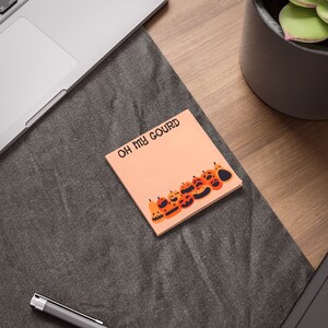 May include: A peach-colored sticky note with the text "OH MY GOURD" and a row of orange and black jack-o'-lantern faces.