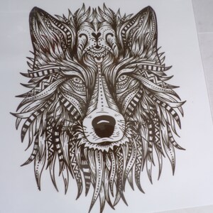 May include: A black and white line drawing of a wolf's head with intricate patterns and designs.