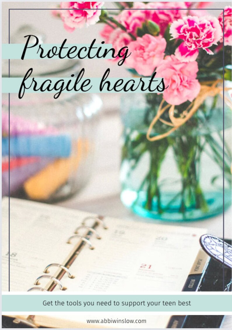 May include: A close-up of a pink carnation bouquet in a blue glass jar, with a planner and the text "Protecting fragile hearts" and "Get the tools you need to support your teen best" on a white surface.