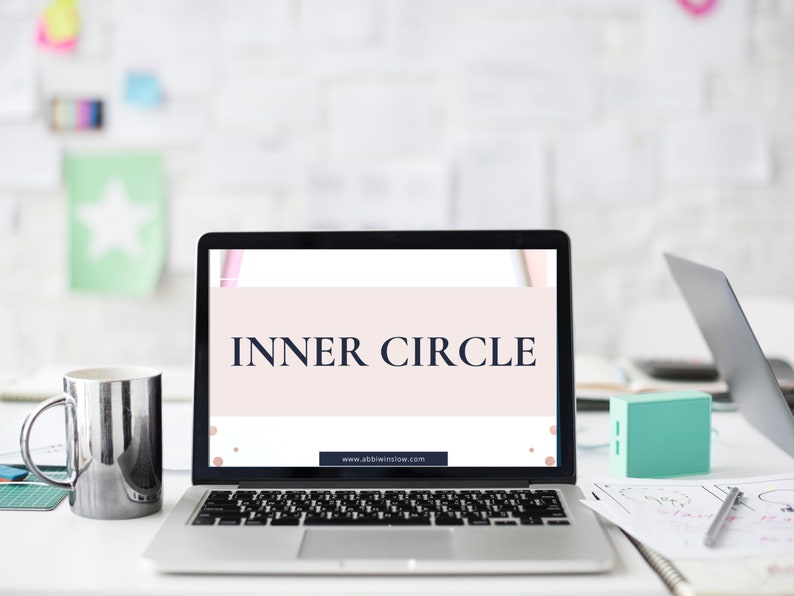 May include: A laptop computer with a white background and the text "INNER CIRCLE" displayed on the screen. The website address "www.abbieinshaw.com" is visible at the bottom of the screen.