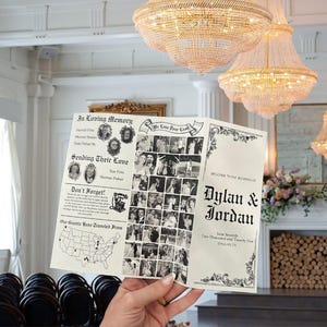 以下が含まれることがあります： 手で持たれた結婚式のプログラム。装飾的な文字で「Dylan & Jordan」の名前が書かれています。プログラムには、記念セクション、写真、地図が含まれています。背景にはシャンデリアと暖炉が写っています。
