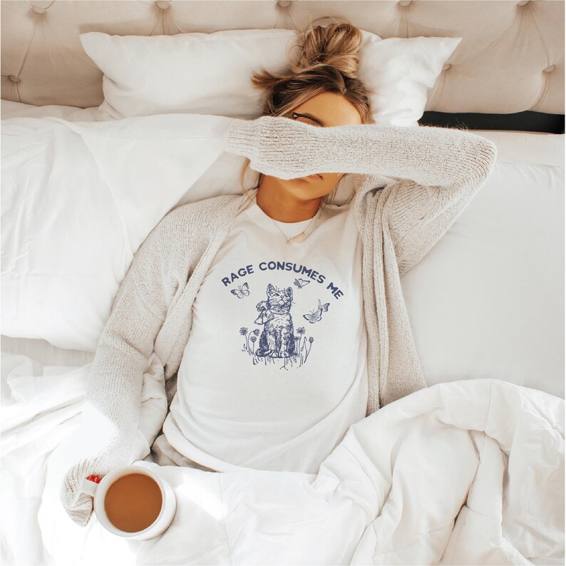 Rage Consumes Me cat meme shirt, blue retro and vintage style kitten with butterflies design on white cotton Bella Canvas tee. Relatable gift for cat moms and introverts. Perfect funny Secret Santa gift under 30 dollars.