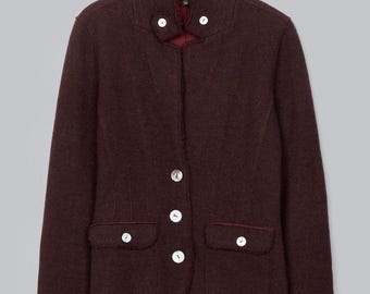 May include: A dark burgundy jacket with a high collar, long sleeves, and a button-front closure. The jacket features two front flap pockets, each secured with a single white button, and a frayed edge detail along the seams and collar.