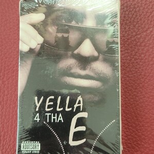 May include: A CD case with a black and white image of a person wearing sunglasses. The text "YELLA 4 THA E" is displayed in white. The case is wrapped in clear plastic. The Parental Advisory Explicit Lyrics logo is visible.