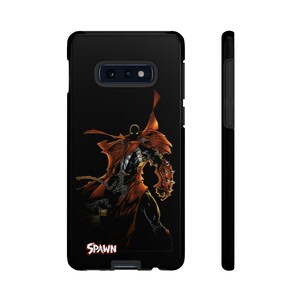 May include: Black phone case featuring a red and black image of Spawn, a comic book character, with the word "Spawn" in red lettering at the bottom.