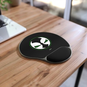 May include: Black and green mouse pad with a white Spawn logo. The mouse pad has a wrist rest.