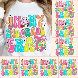 May include: A set of 10 colourful graphic designs for t-shirts featuring the text "In My [Grade] Era" with a rainbow colour scheme and a disco ball graphic. The designs include Kindergarten, 1st Grade, 2nd Grade, 3rd Grade, 4th Grade, 5th Grade, Pre-K, and Preschool.