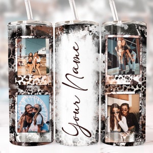 May include: A personalized tumbler with a black, white, and brown design, featuring a cow print pattern and space for photos. The tumbler includes a straw and the text "Your Name" in a cursive font.
