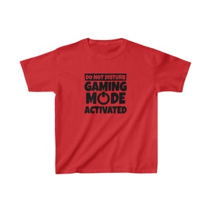 May include: Red youth t-shirt with black text that reads "Do Not Disturb Gaming Mode Activated" with a power button symbol.