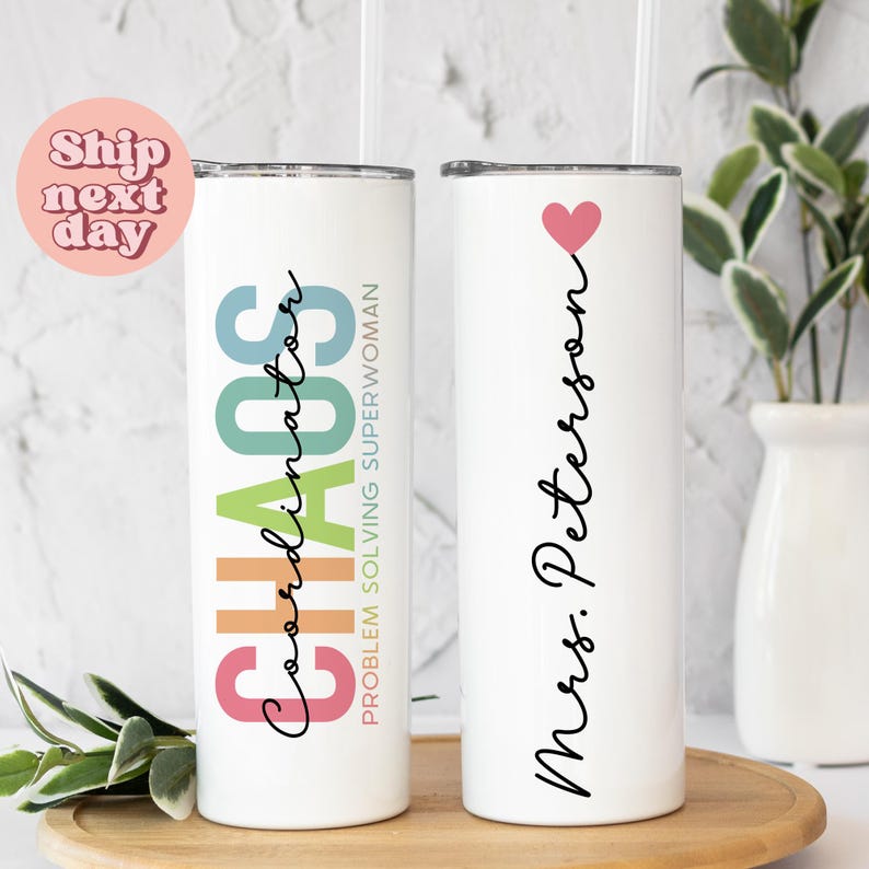 Puede incluir: Dos vasos aislados blancos con pajitas. Uno dice "CHAOS Coordinator PROBLEM SOLVING SUPERWOMAN" en texto colorido. El otro vaso tiene un coraz&oacute;n rosa y dice "Mrs. Peterson" en escritura negra.
