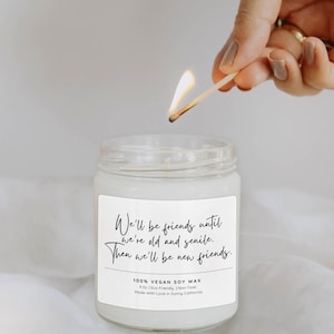 A hand lighting a candle in a jar, with a label that reads "We'll be friends until we're old andsenile. Then we'll be new friends."
