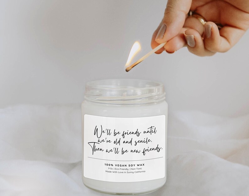 A hand lighting a candle in a jar, with a label that reads "We'll be friends until we're old andsenile. Then we'll be new friends."
