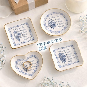 May include: Four white ceramic trinket dishes with gold rims, each with a different shape. They feature blue floral designs and inspirational text. One heart-shaped dish holds a ring. The text "PERSONALIZED GIFT" is also visible.