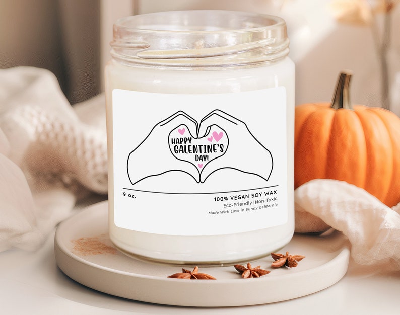 a candle with a picture of two hands holding each other