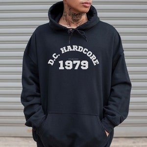 May include: Black hooded sweatshirt with white text that reads "D.C. HARDCORE ESTABLISHED 1979".